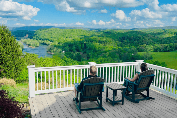Image of couple overlooking New River on Verandah at Lilly Valley Inn
